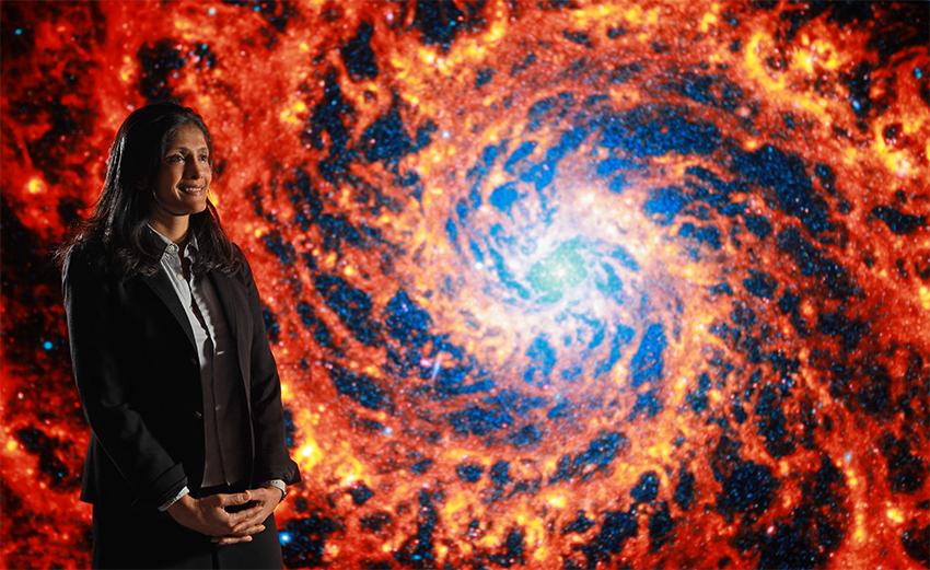 Rupali Chandar博士.D.，站在五彩缤纷的太空图像前